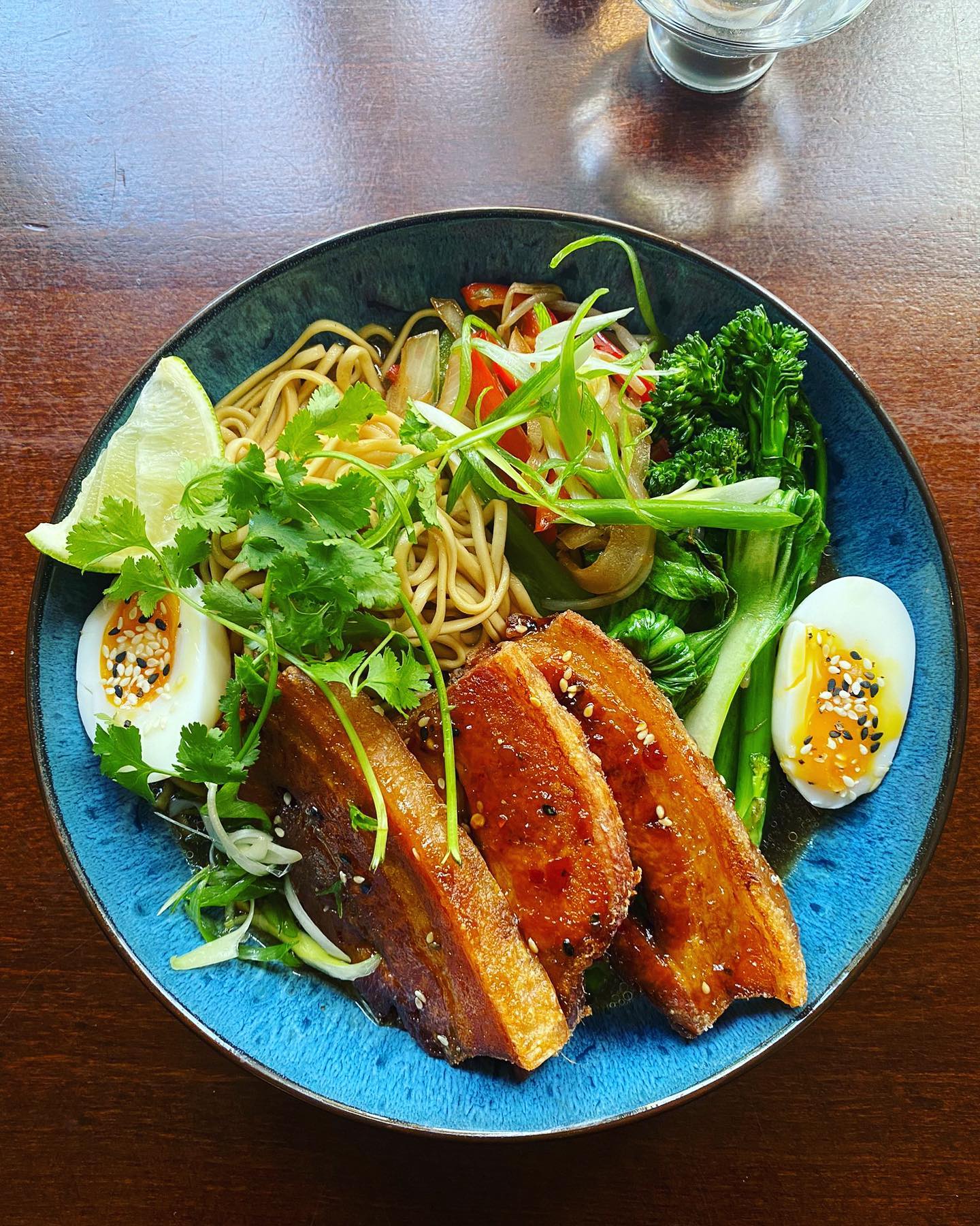 Crispy Belly Pork Ramen, Sautéed Vegetables, Asian Broth, Soft Boiled Egg, Sesame, Fresh Chilli, Spring Onion and Coriander